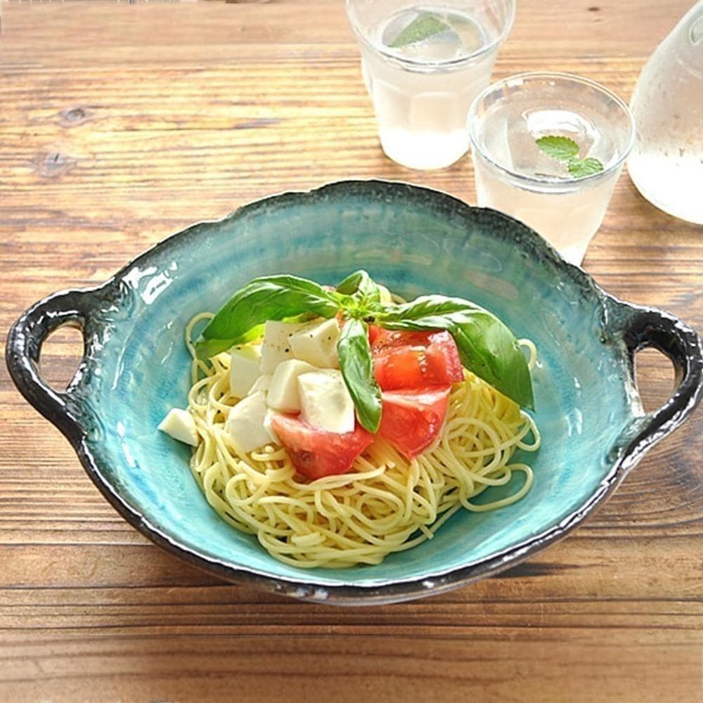 Deep ceramic bowl with double-ear handles, perfect for salads or pasta.