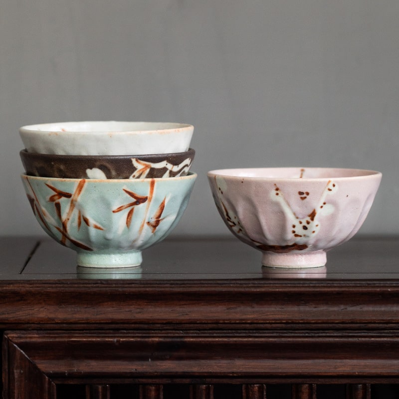 Close-up of a handcrafted ceramic bowl with elegant brushstroke designs.