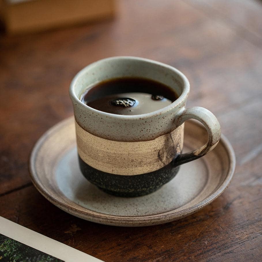 Elegant ceramic cup and saucer set for coffee or tea.