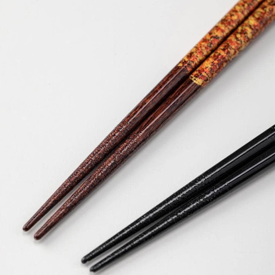 Single set of lacquered chopsticks with intricate gold design