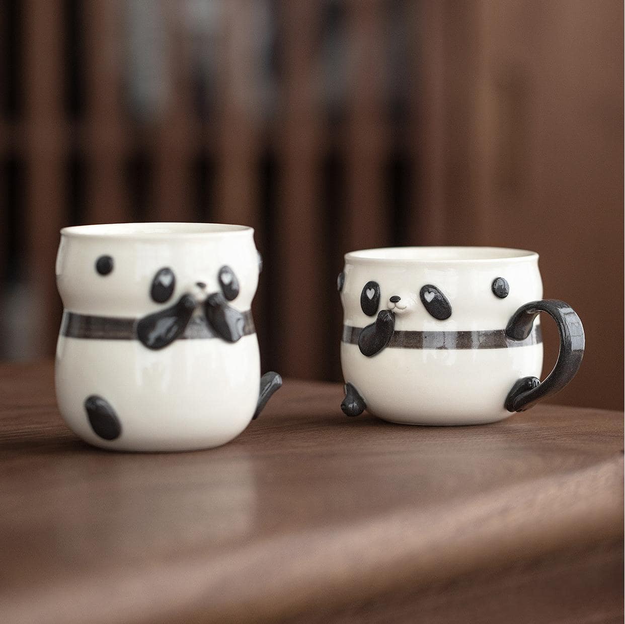 Adorable panda ceramic cup with expressive face and paw accents