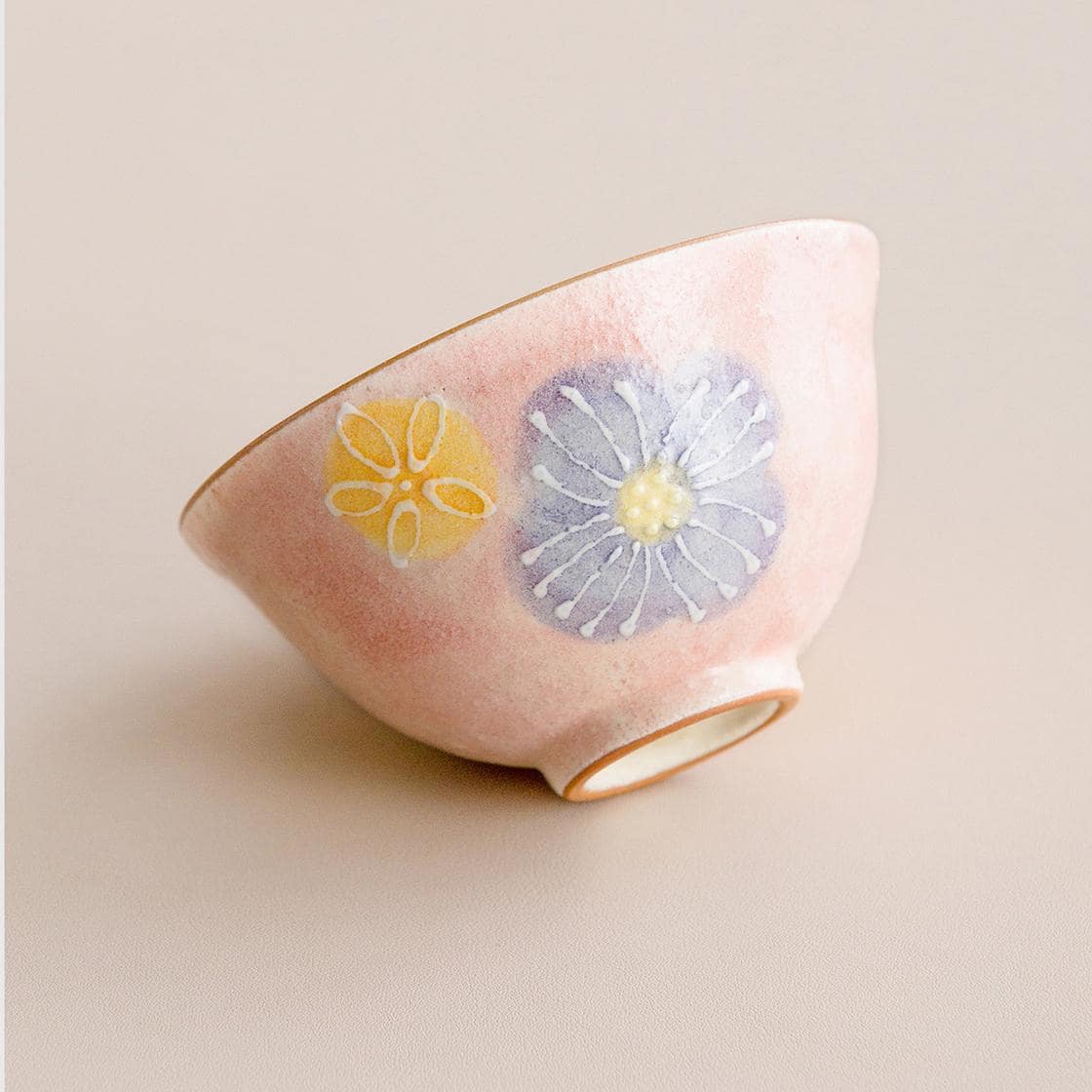 Artisan-crafted ceramic bowls arranged to highlight their intricate blossom design