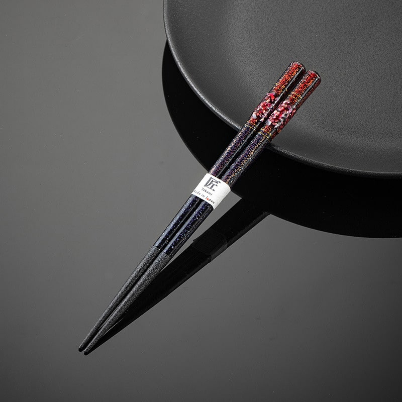 Handcrafted Beiyun chopsticks on a modern black plate.