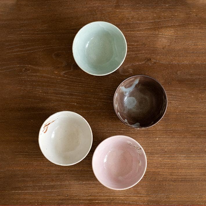 Hand holding a ceramic bowl highlighting its intricate details.