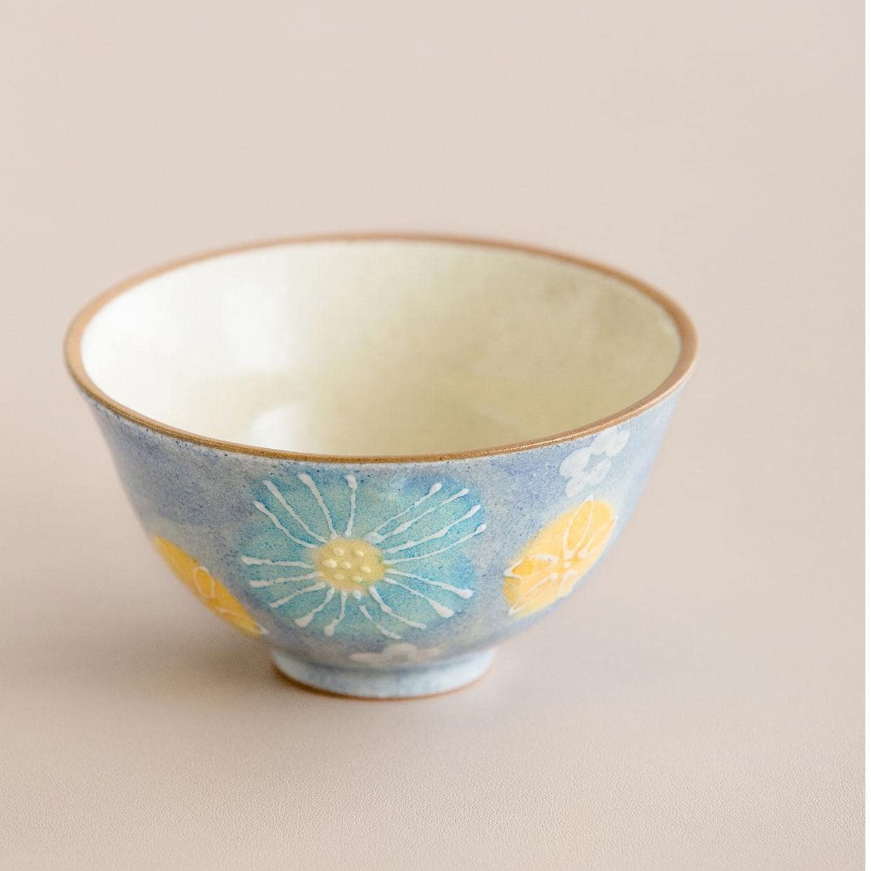 Artisan-crafted ceramic bowls arranged to highlight their intricate blossom design