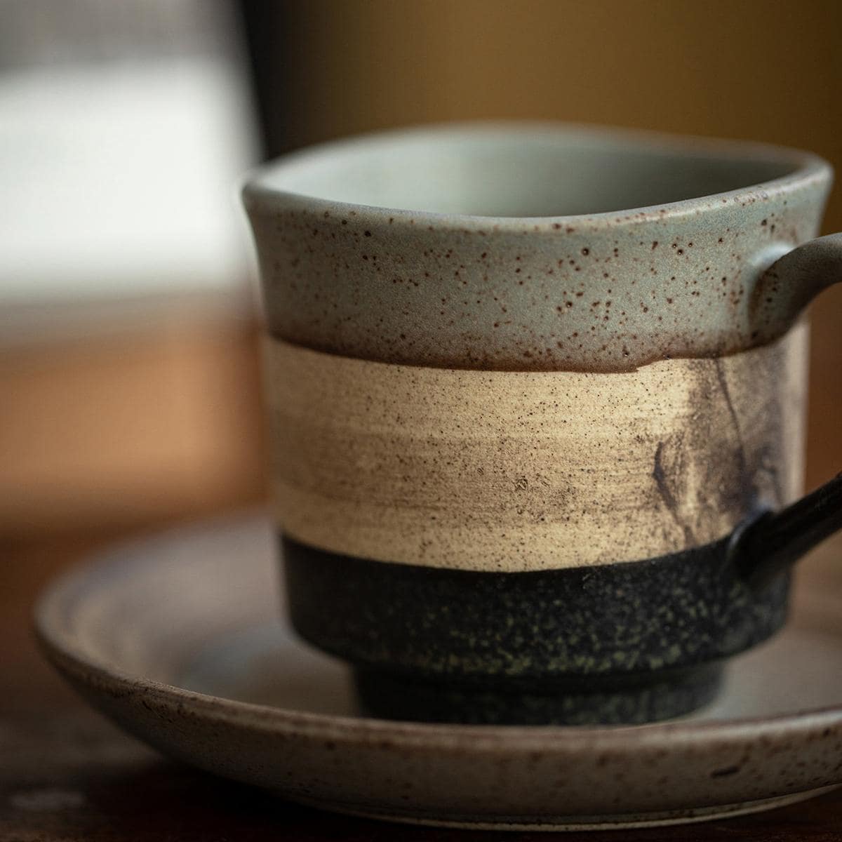 Modern rustic ceramic cup for cozy beverage moments.