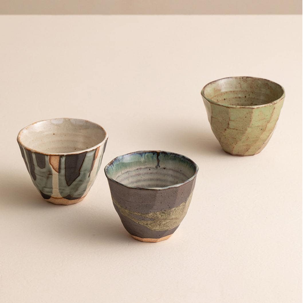 Close-up of Japanese pottery cups with unique glaze textures