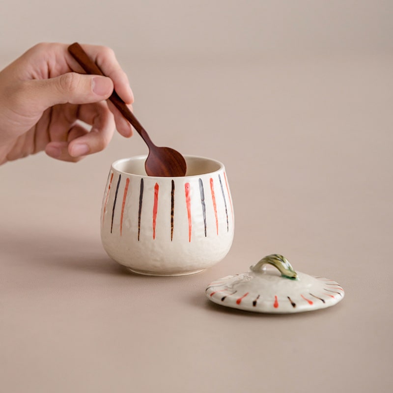 Close-up of ceramic stew pot with striped design