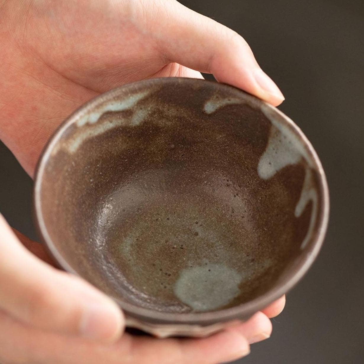 Four beautifully crafted ceramic bowls on a wooden table.