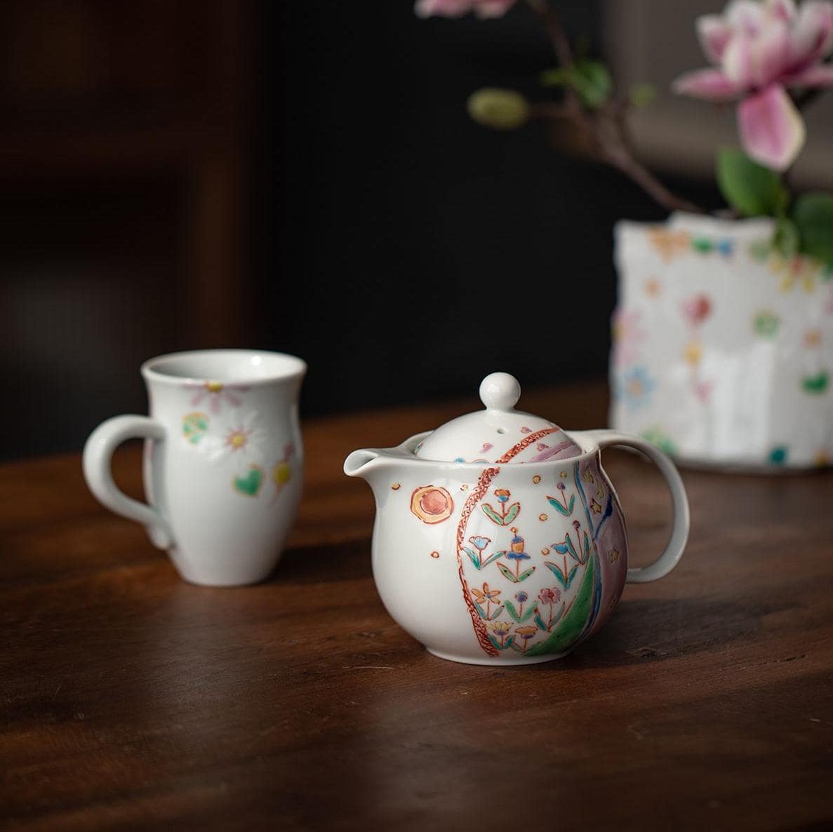 Complete ceramic tea set with vase on display
