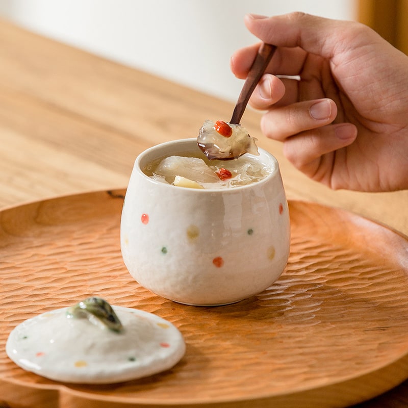 Beautiful lidded ceramic pots on a wooden table