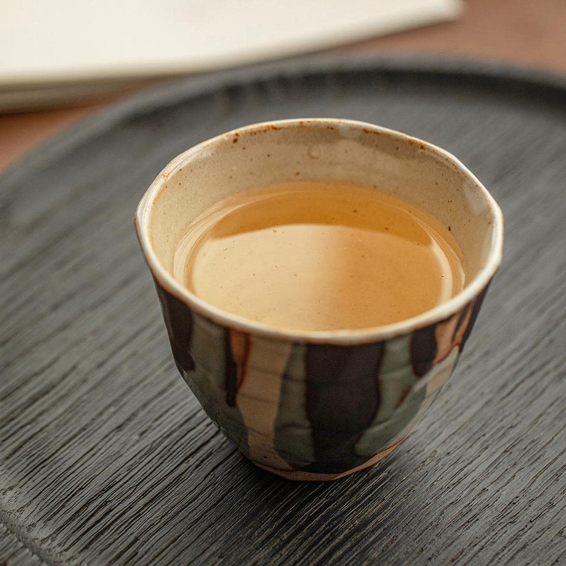 Four handcrafted Japanese ceramic cups in earthy tones