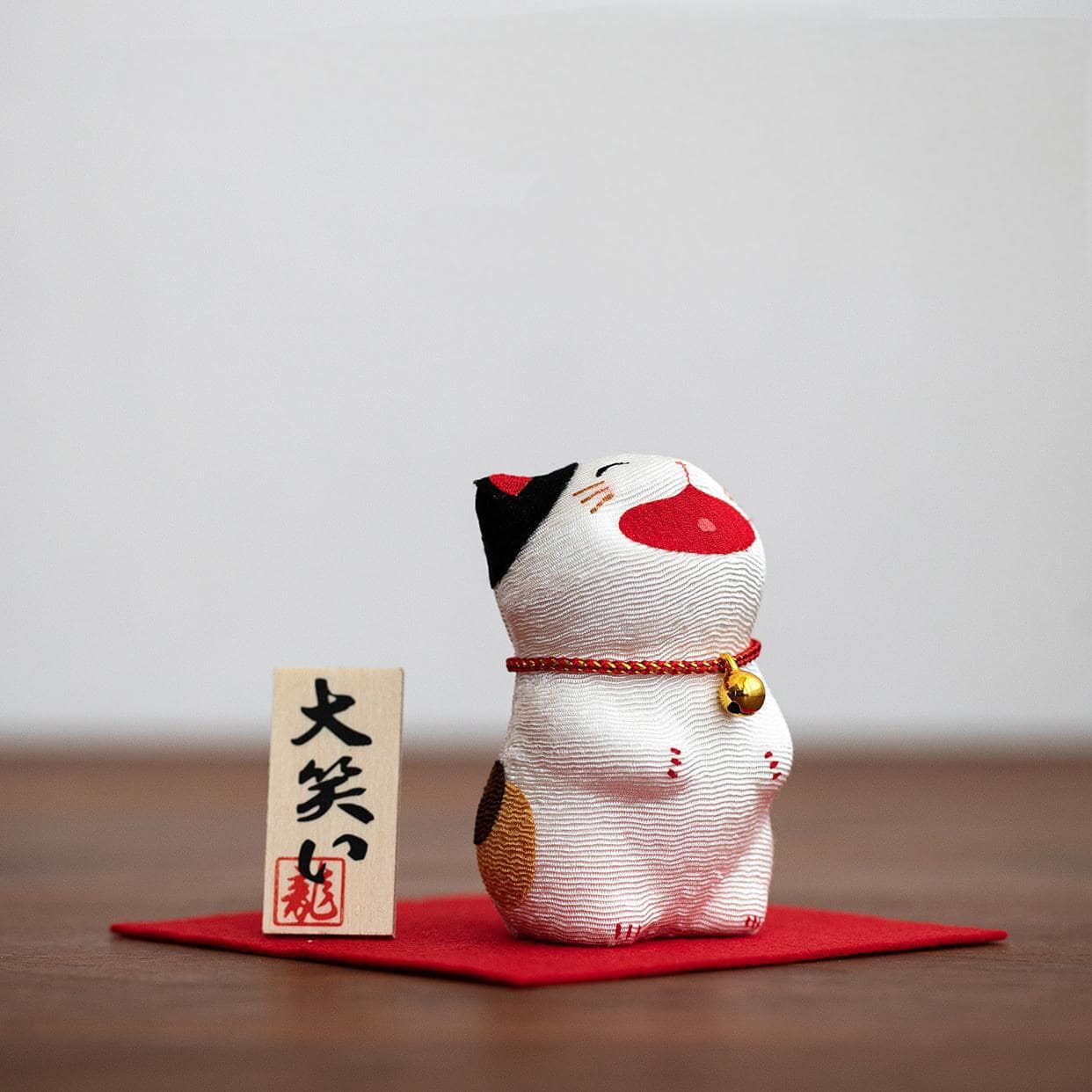 Dragon Tiger Hall lucky cat on red mat with golden bell