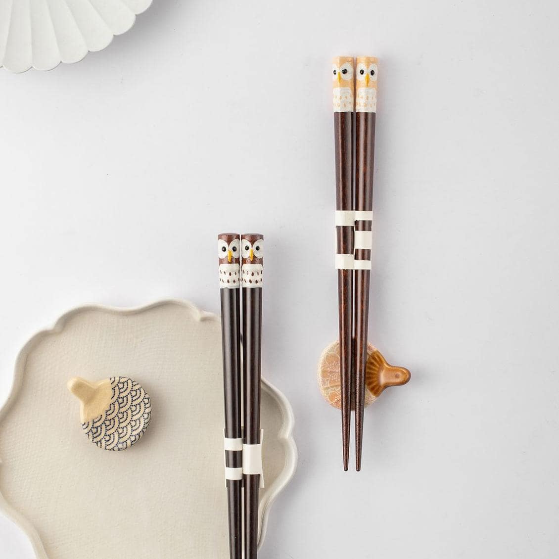 Close-up of handcrafted owl design on wooden chopsticks
