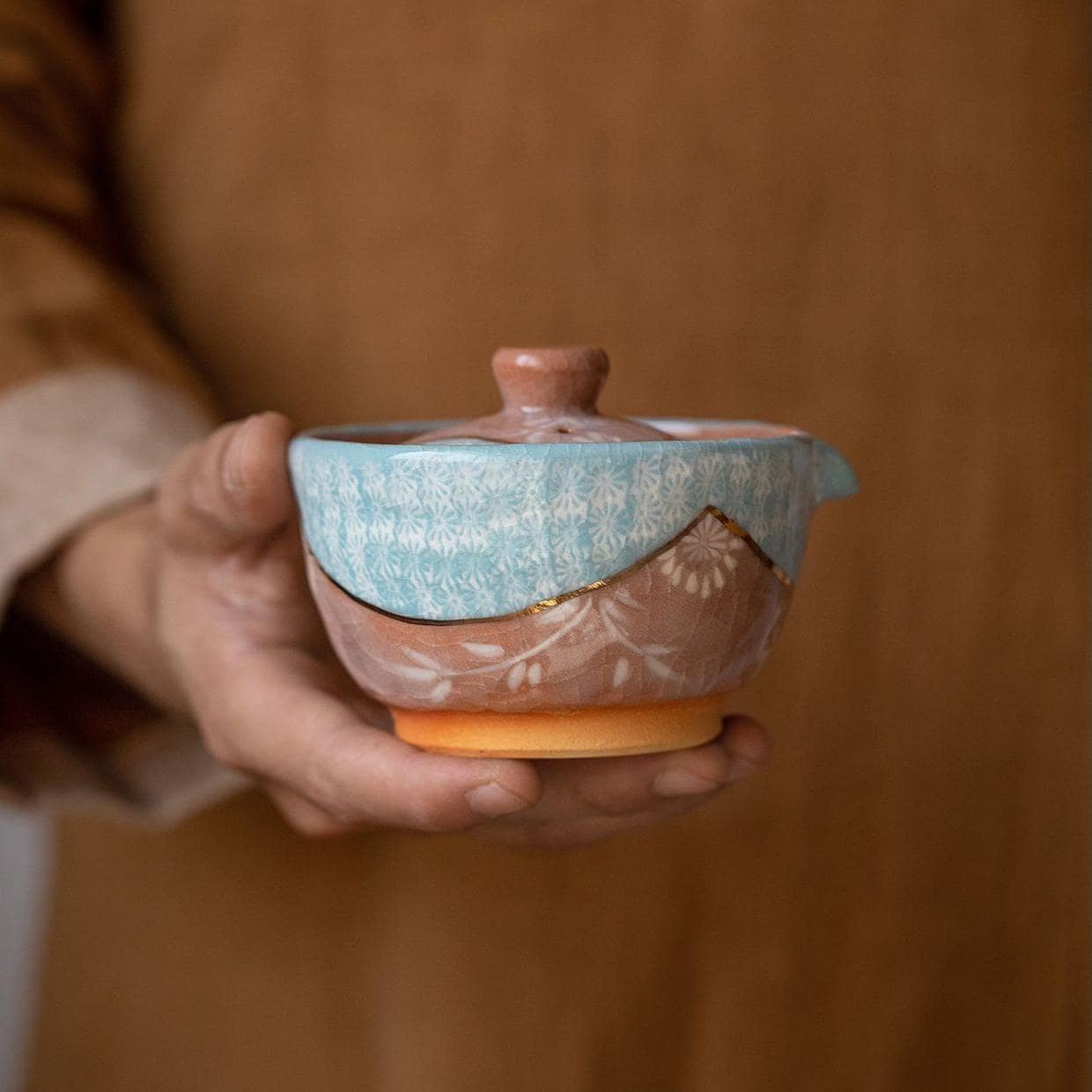 Elegant blue and brown ceramic tea set for luxury tea moments.