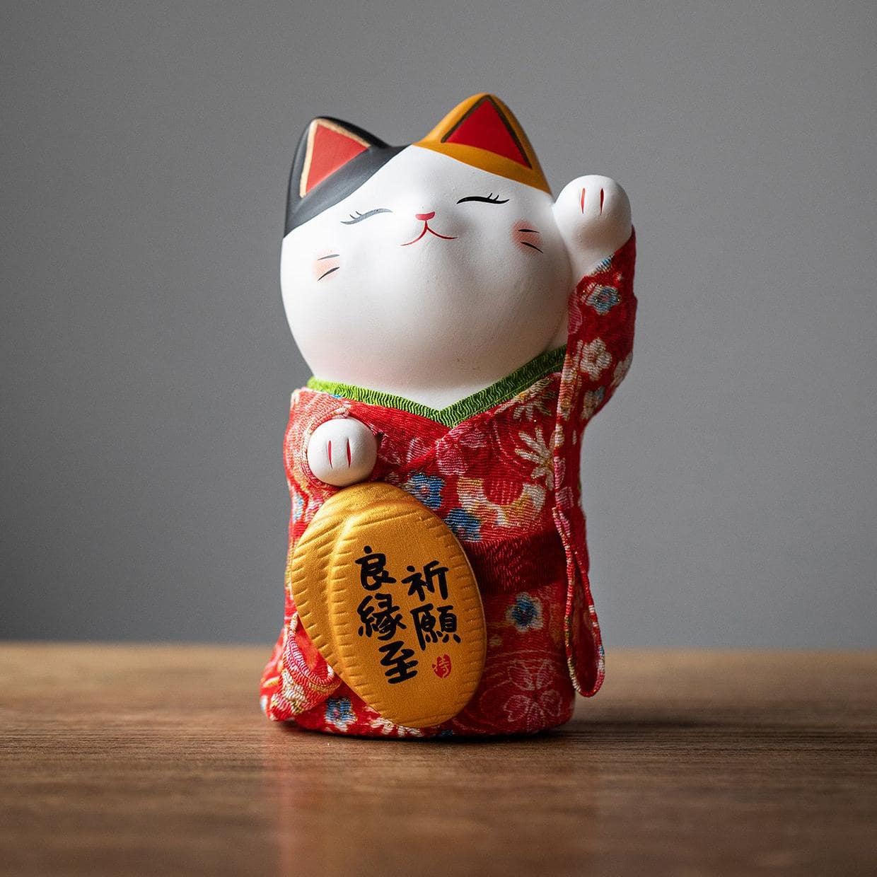 Handcrafted Japanese lucky cat with kimono details for home decor.