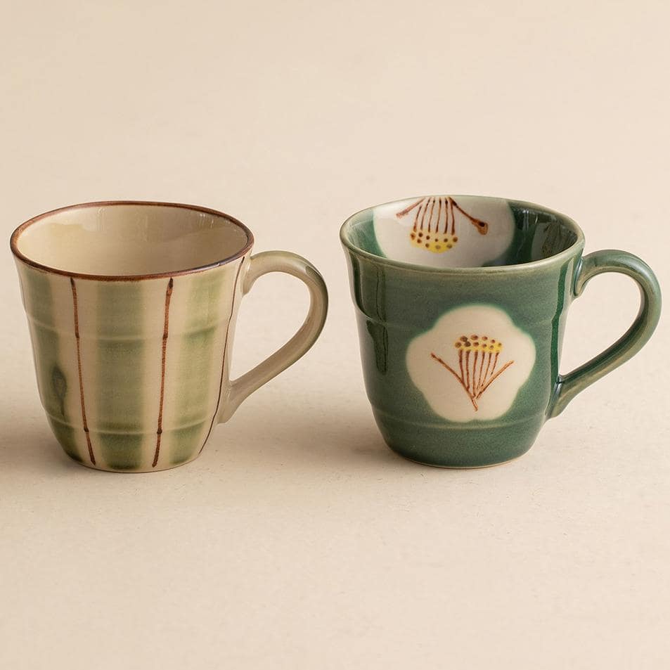 Ceramic mugs with floral patterns displayed on a wooden gift box