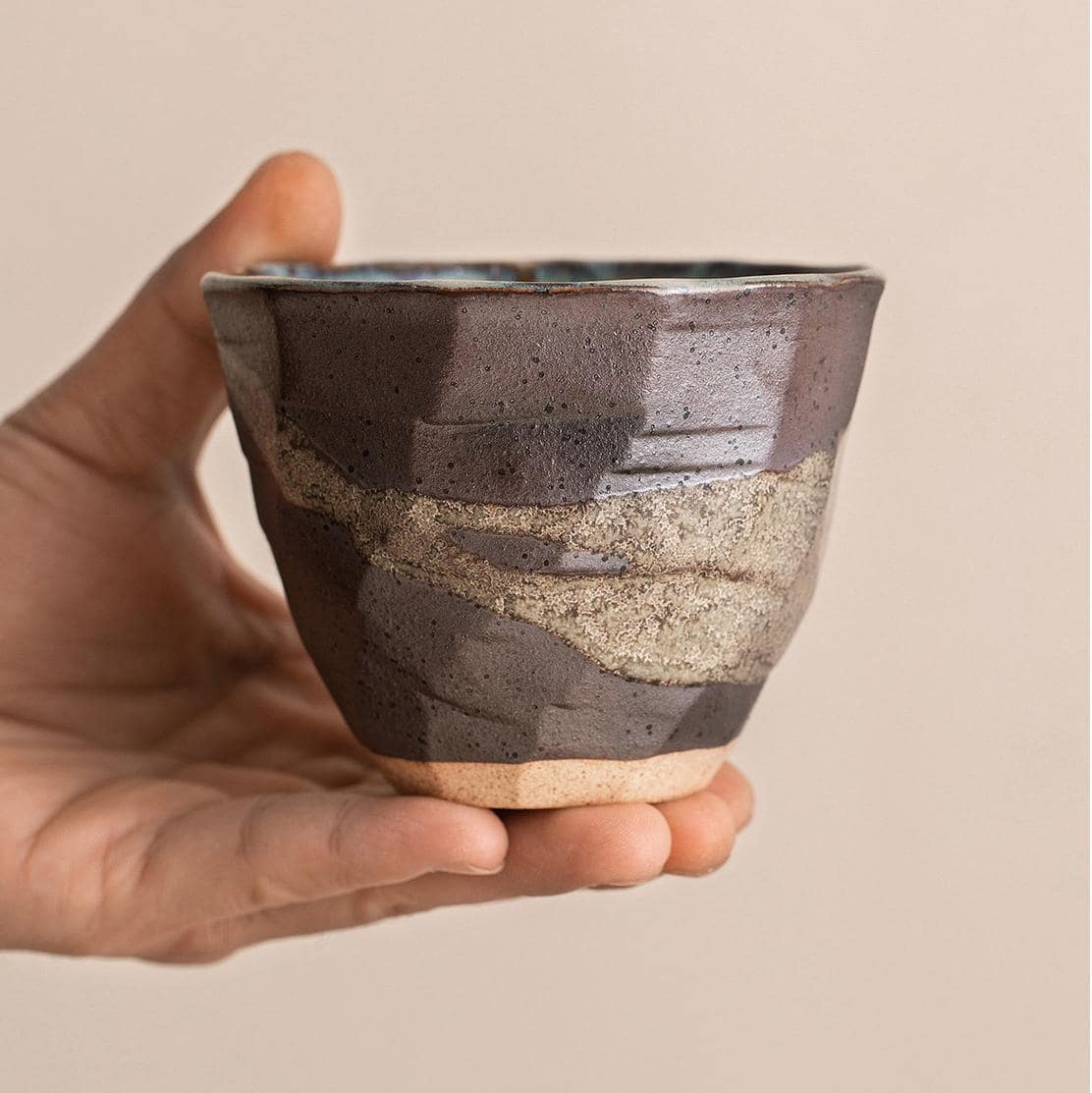 Close-up of Japanese pottery cups with unique glaze textures