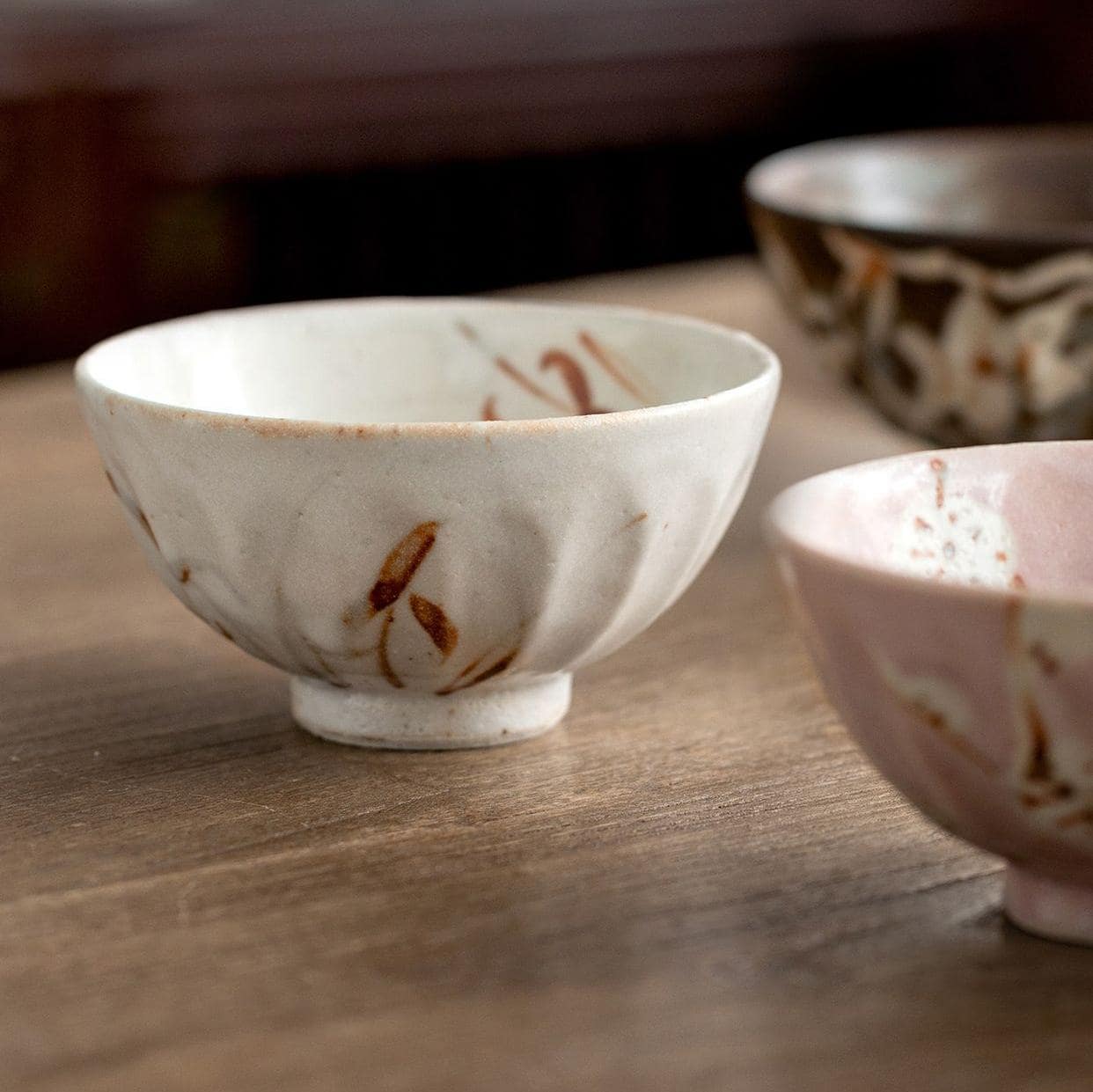 Close-up of a handcrafted ceramic bowl with elegant brushstroke designs.