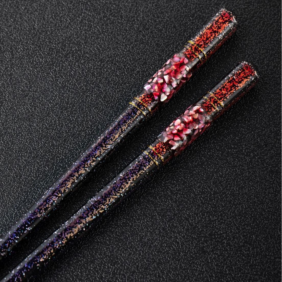 Elegant Japanese wooden chopsticks with red and black accents.