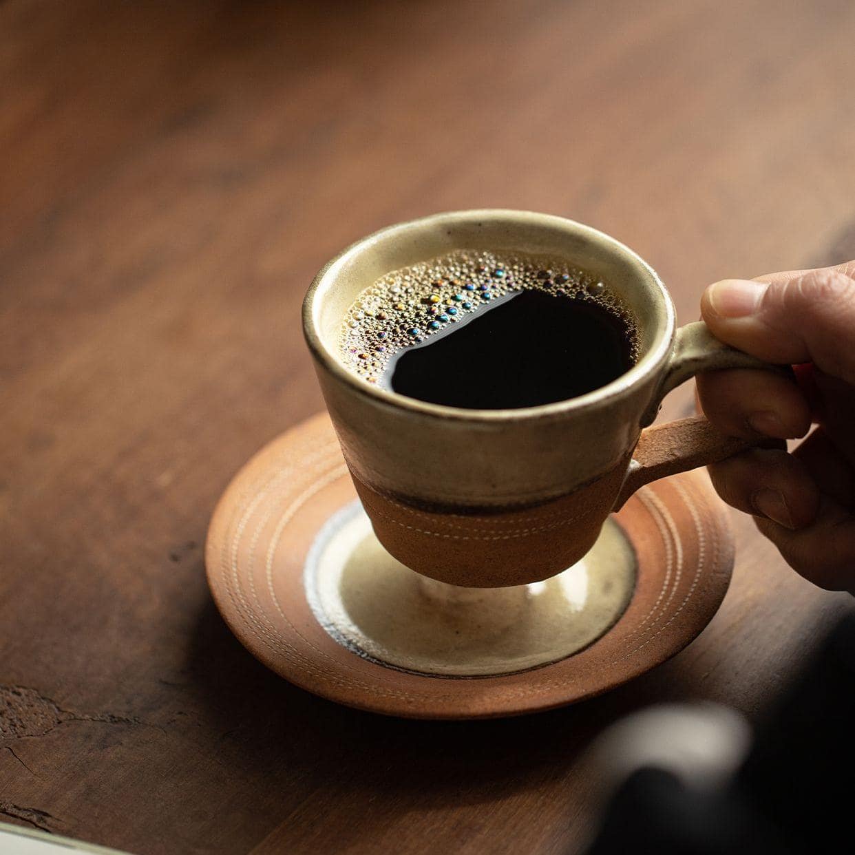 Artistic ceramic cup and saucer set for elegant dining.