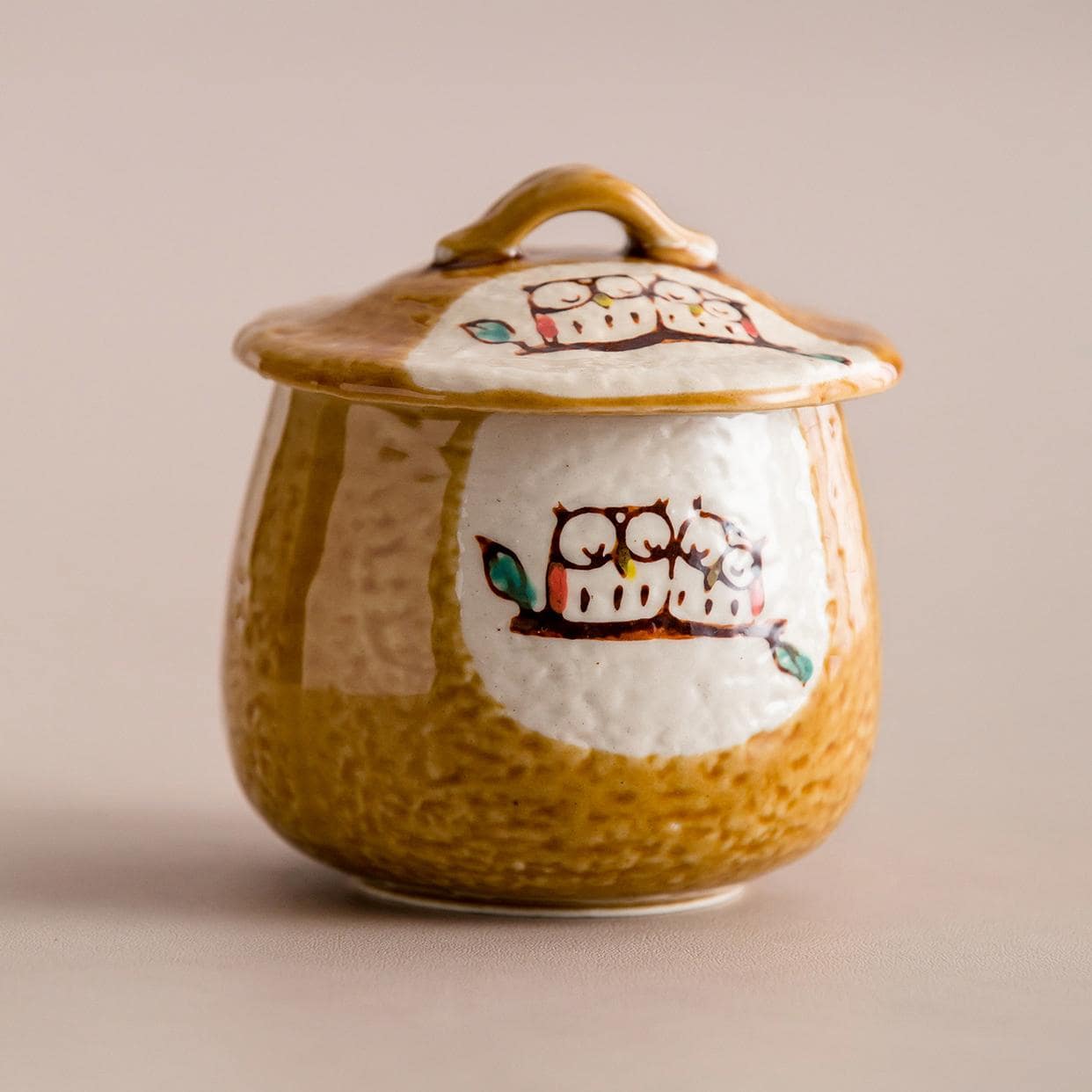 Close-up of ceramic stew pot with striped design