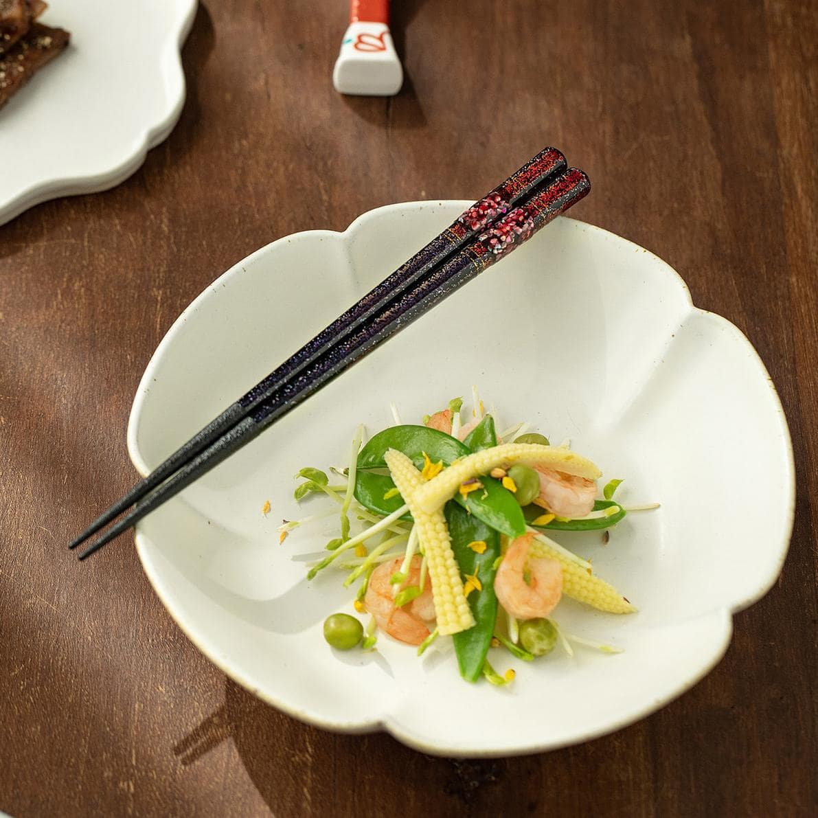 Handcrafted Beiyun chopsticks on a modern black plate.