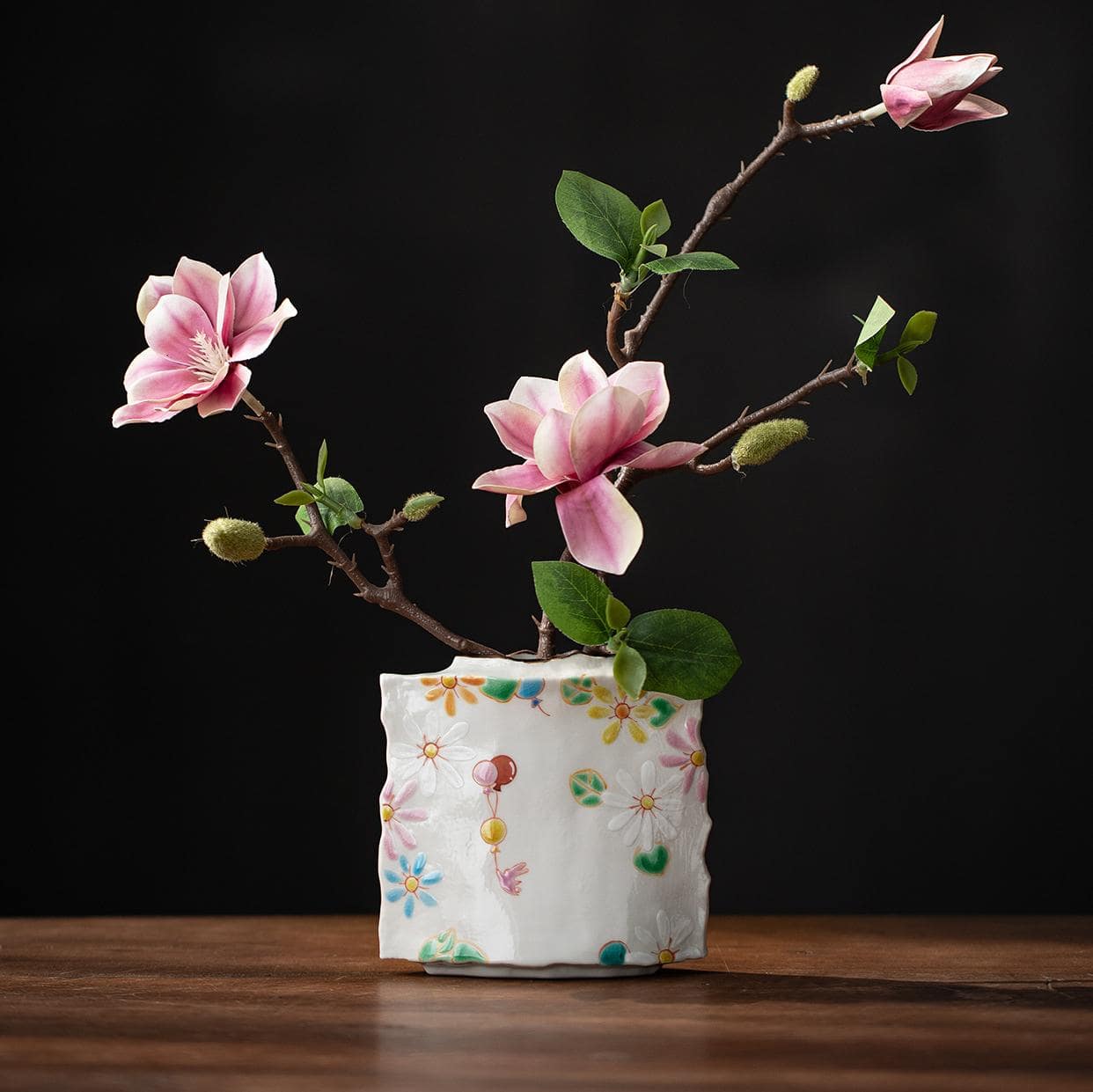 Complete ceramic tea set with vase on display