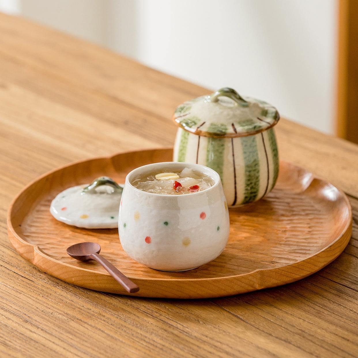 Beautiful lidded ceramic pots on a wooden table