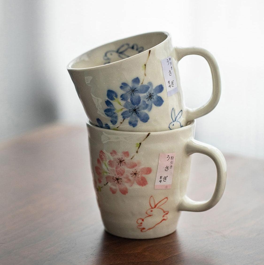 Shelf showcasing a collection of artistic ceramic mugs