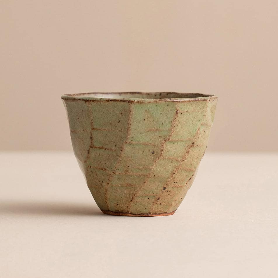 Four handcrafted Japanese ceramic cups in earthy tones