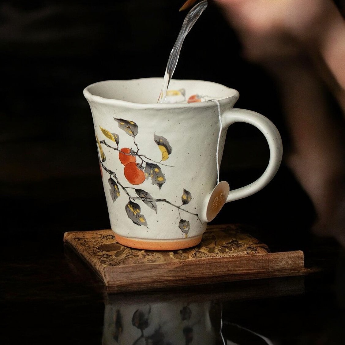 Shelf showcasing a collection of artistic ceramic mugs