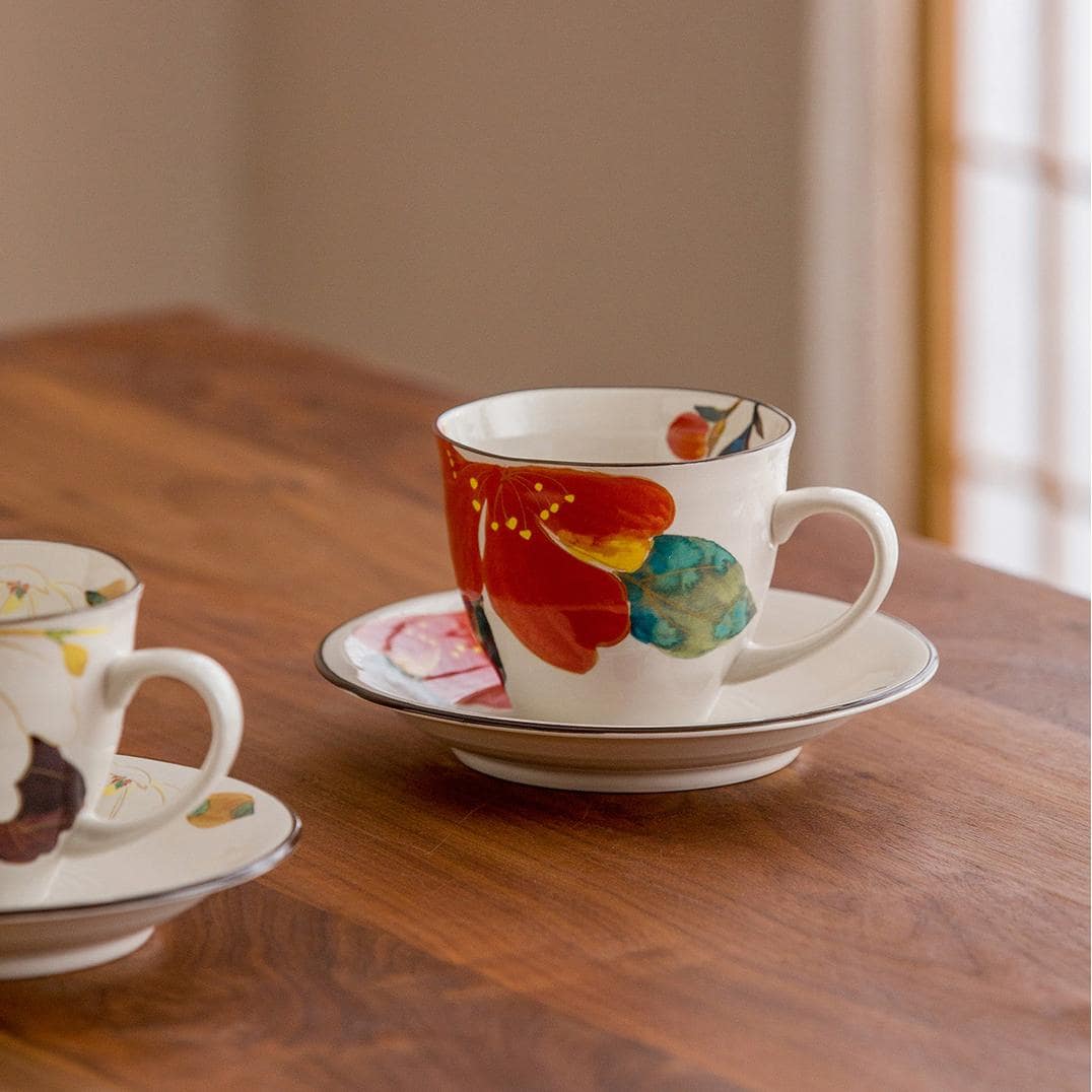 Vibrant cherry blossom and floral design ceramic tea and coffee set.