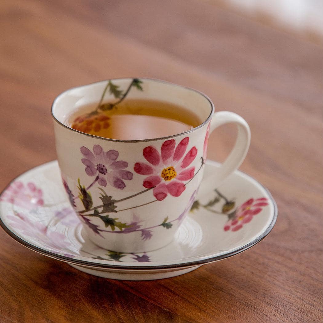 Vibrant cherry blossom and floral design ceramic tea and coffee set.