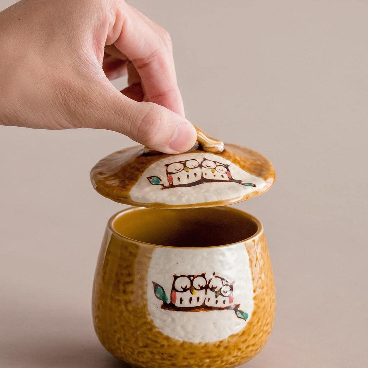 Close-up of ceramic stew pot with striped design