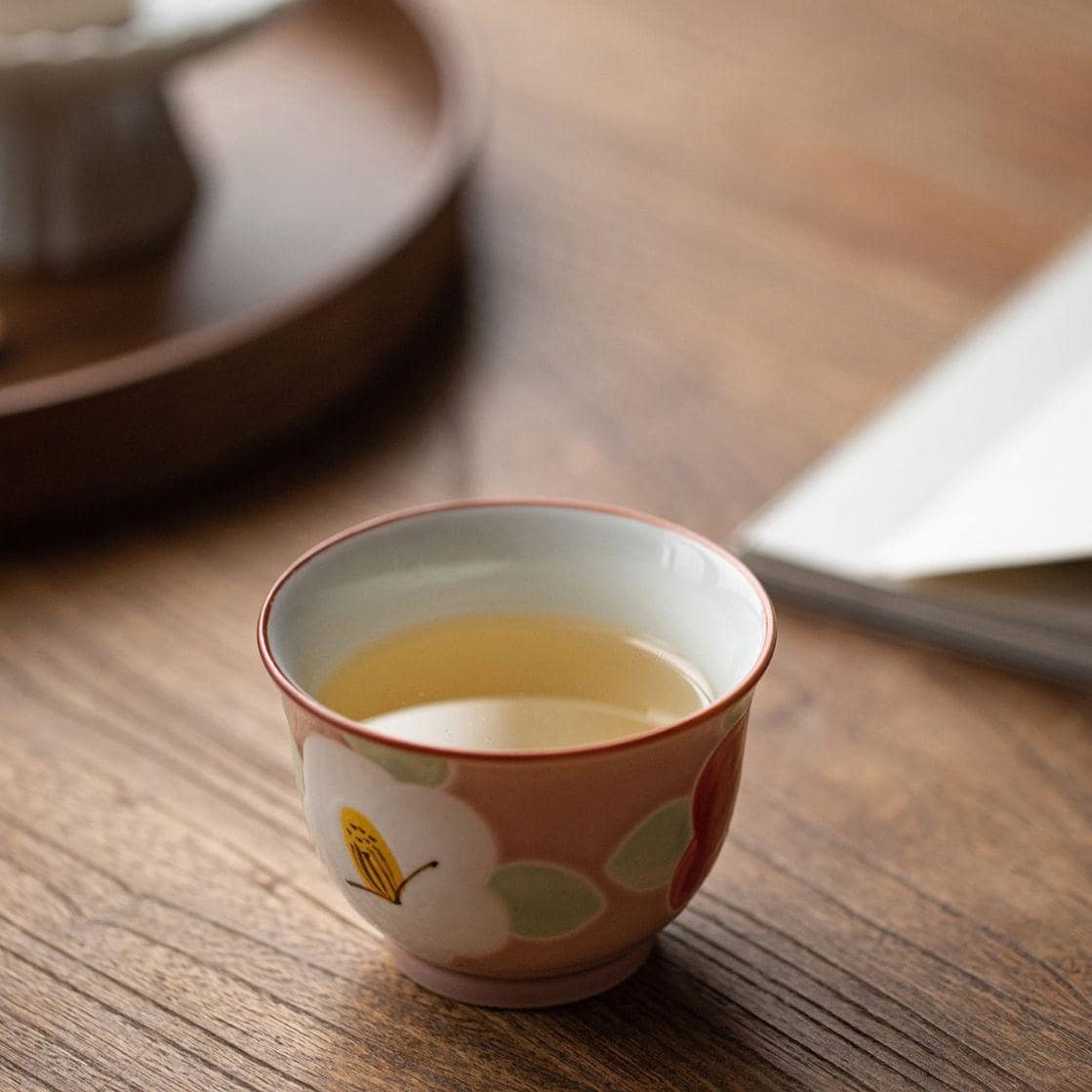 Close-up of floral details on a handcrafted ceramic tea cup.