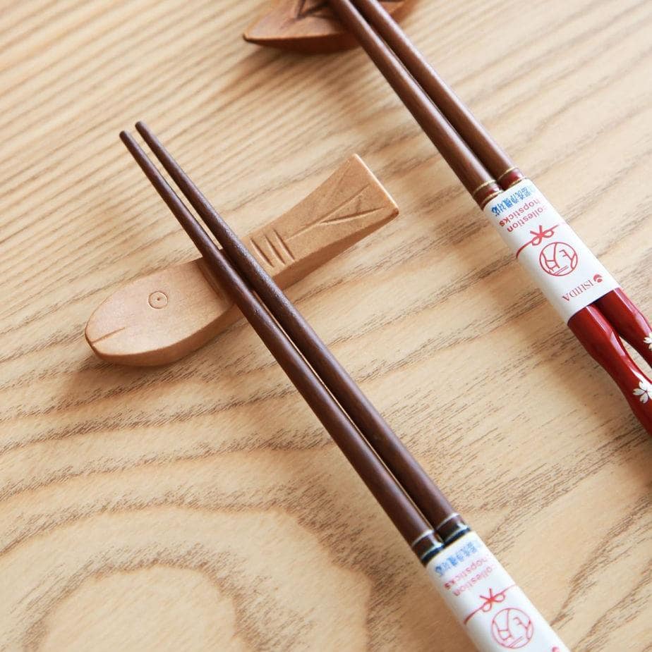 Close-up of sakura-themed lacquered chopsticks in red and blue