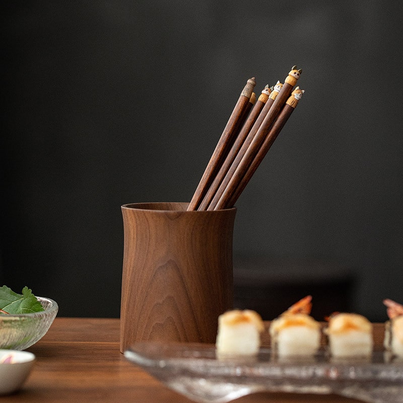 Handcrafted wooden chopsticks displayed in wooden holder