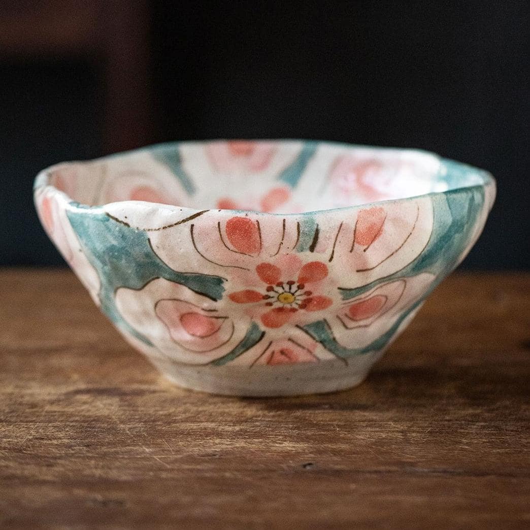 Hand-formed Japanese bowl placed on a rustic wooden surface, highlighting its artisanal craftsmanship