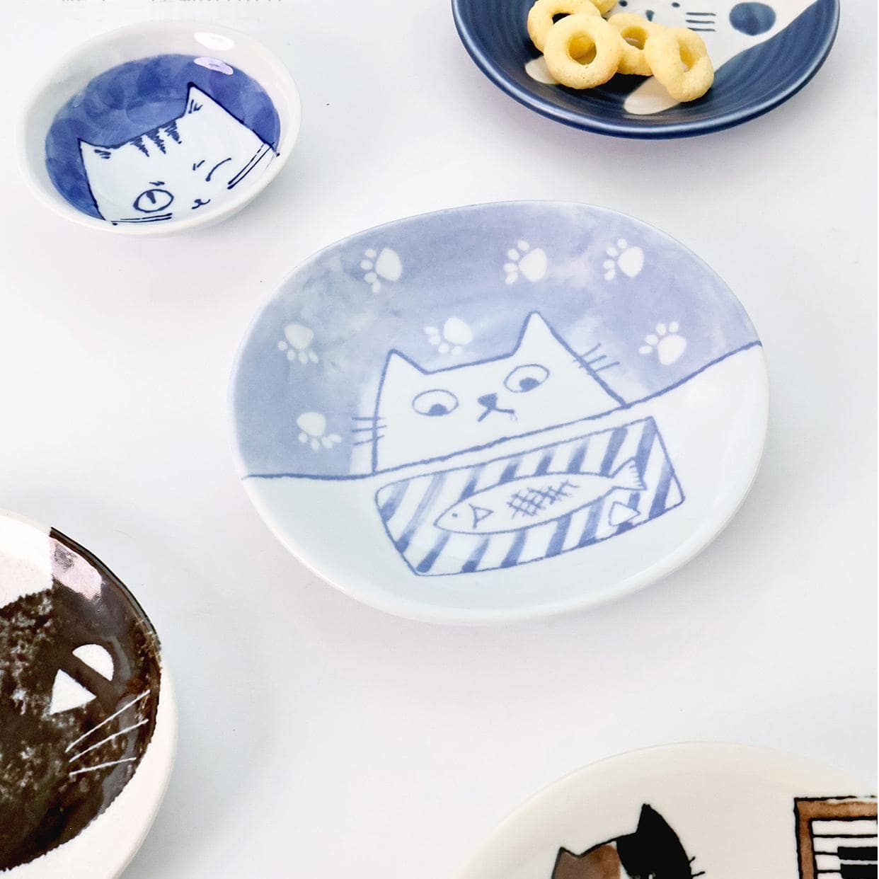 Set of Japanese cat-themed ceramic plates and small bowls