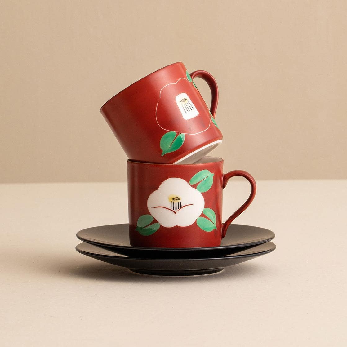 Handcrafted Mino ware coffee cups with intricate red designs.