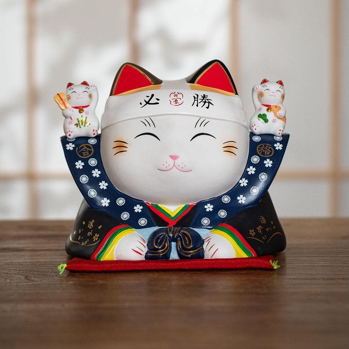 Handcrafted ceramic lucky cats in vibrant traditional designs.