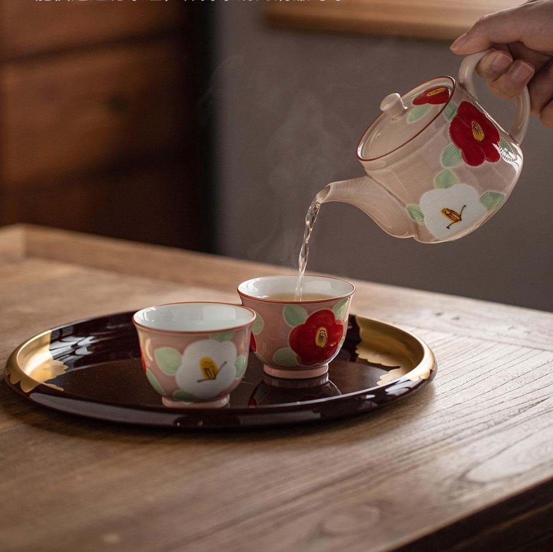 Japanese ceramic tea set with hand-painted camellia flowers.