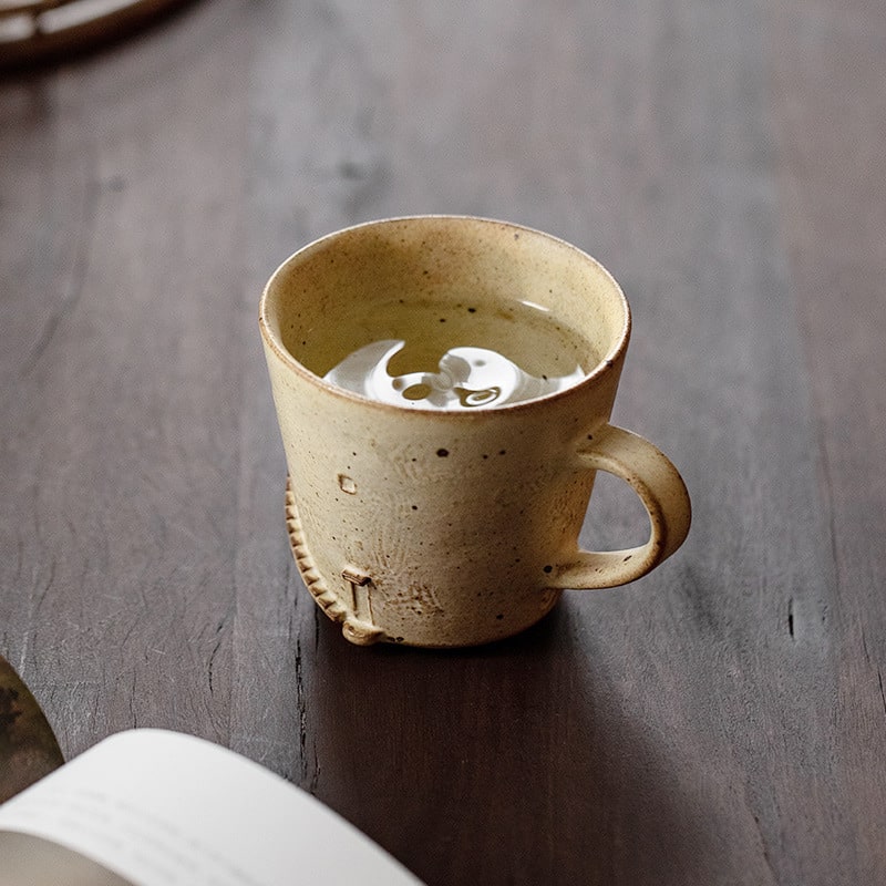 Handmade artisan mug on a wooden table.