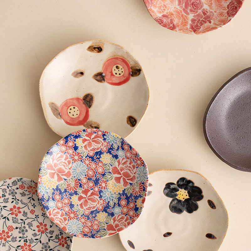 Artistic cup and saucer featuring a vibrant cherry blossom motif