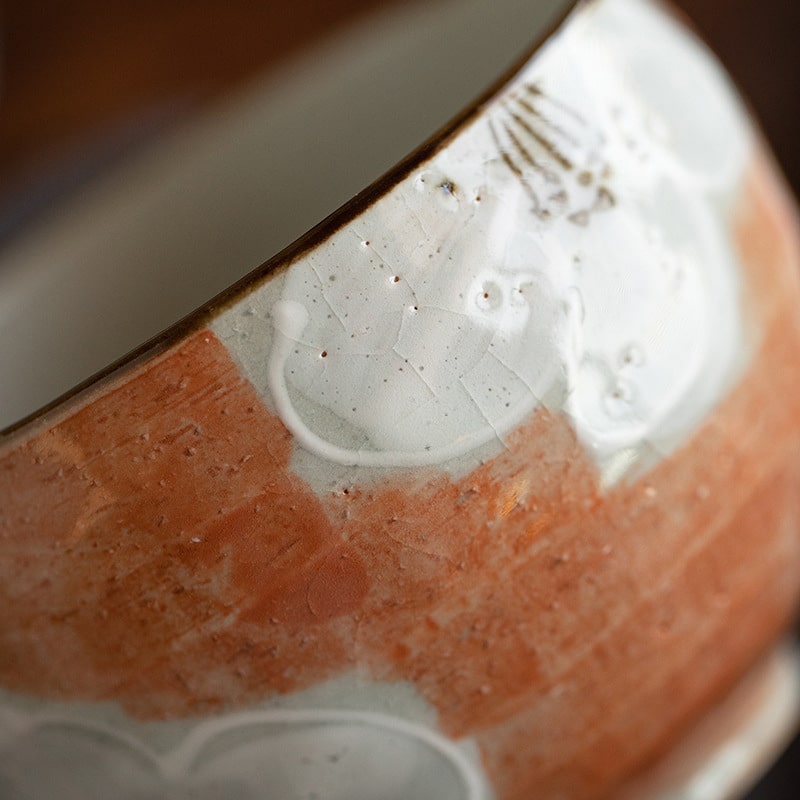 Close-up of hand-painted Japanese ceramic tea cup design