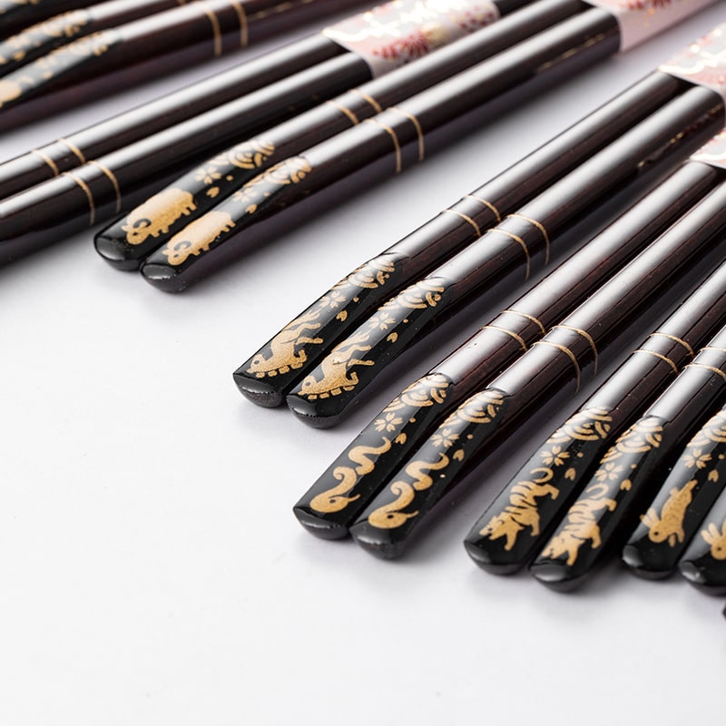 Traditional Japanese chopsticks on a red dining tray