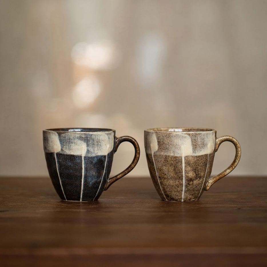 Shelf showcasing a collection of artistic ceramic mugs