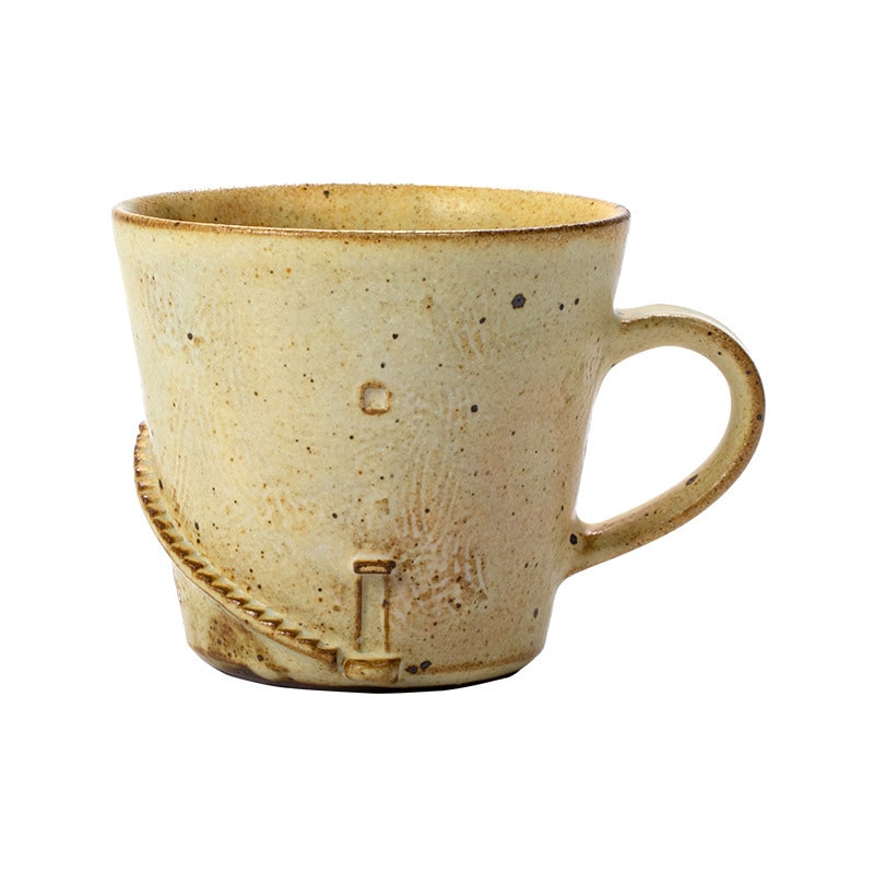 Close-up of handcrafted rustic coffee mug.