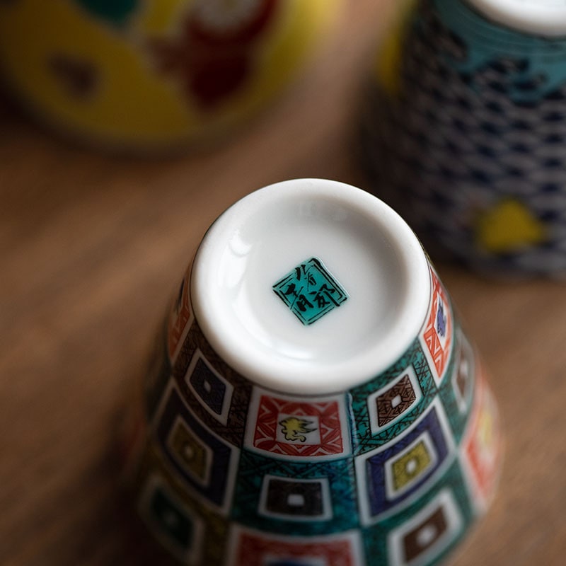 Bottom view of a Japanese porcelain cup showcasing authenticity mark